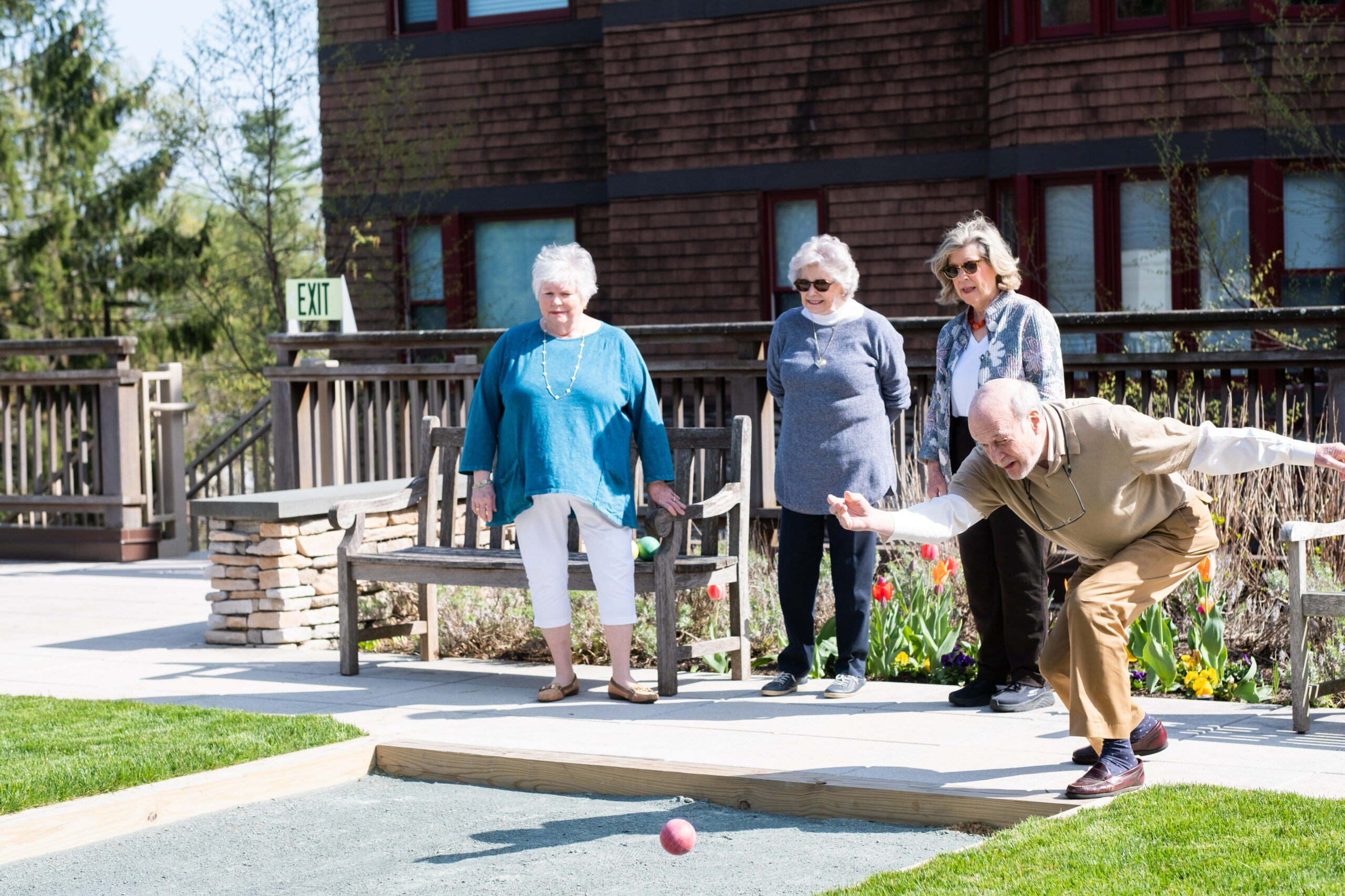 Seniors play Bocce on the rooftop court at Edgehill