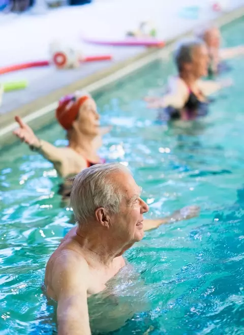 Seniors in swimming aerobics class