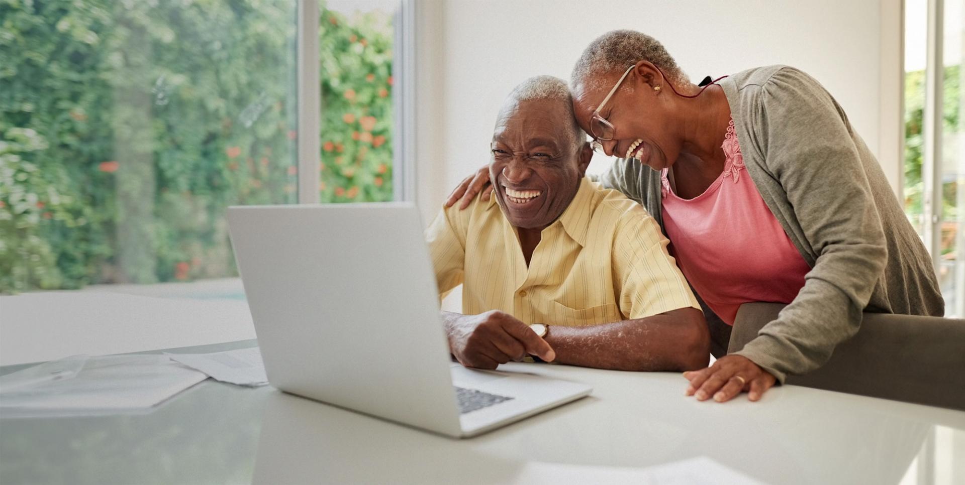 Senior man and woman looking at computer