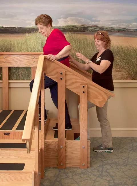 Rehab patient walking up stairs