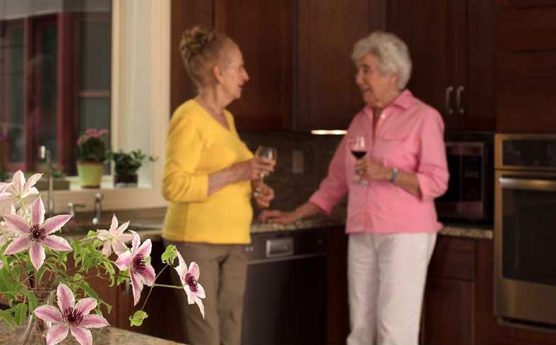 Two senior women drinking wine