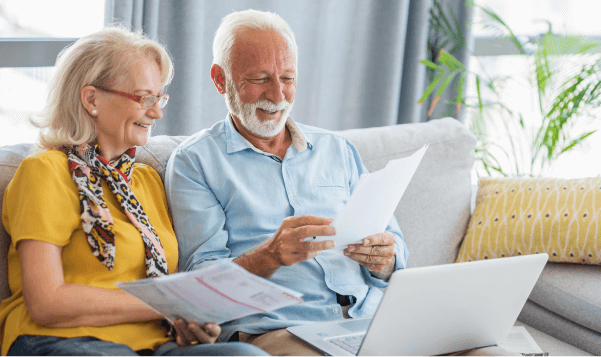 Senior man and woman reviewing financial documents