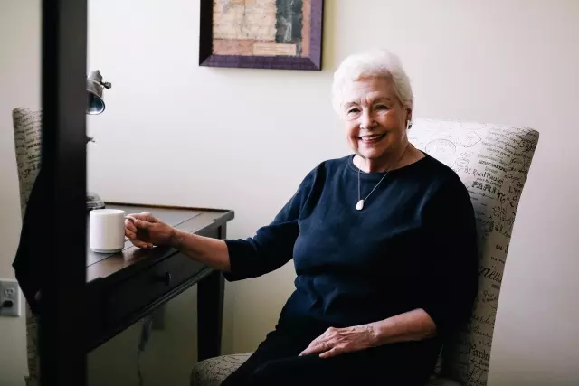 Senior woman having coffee at desk