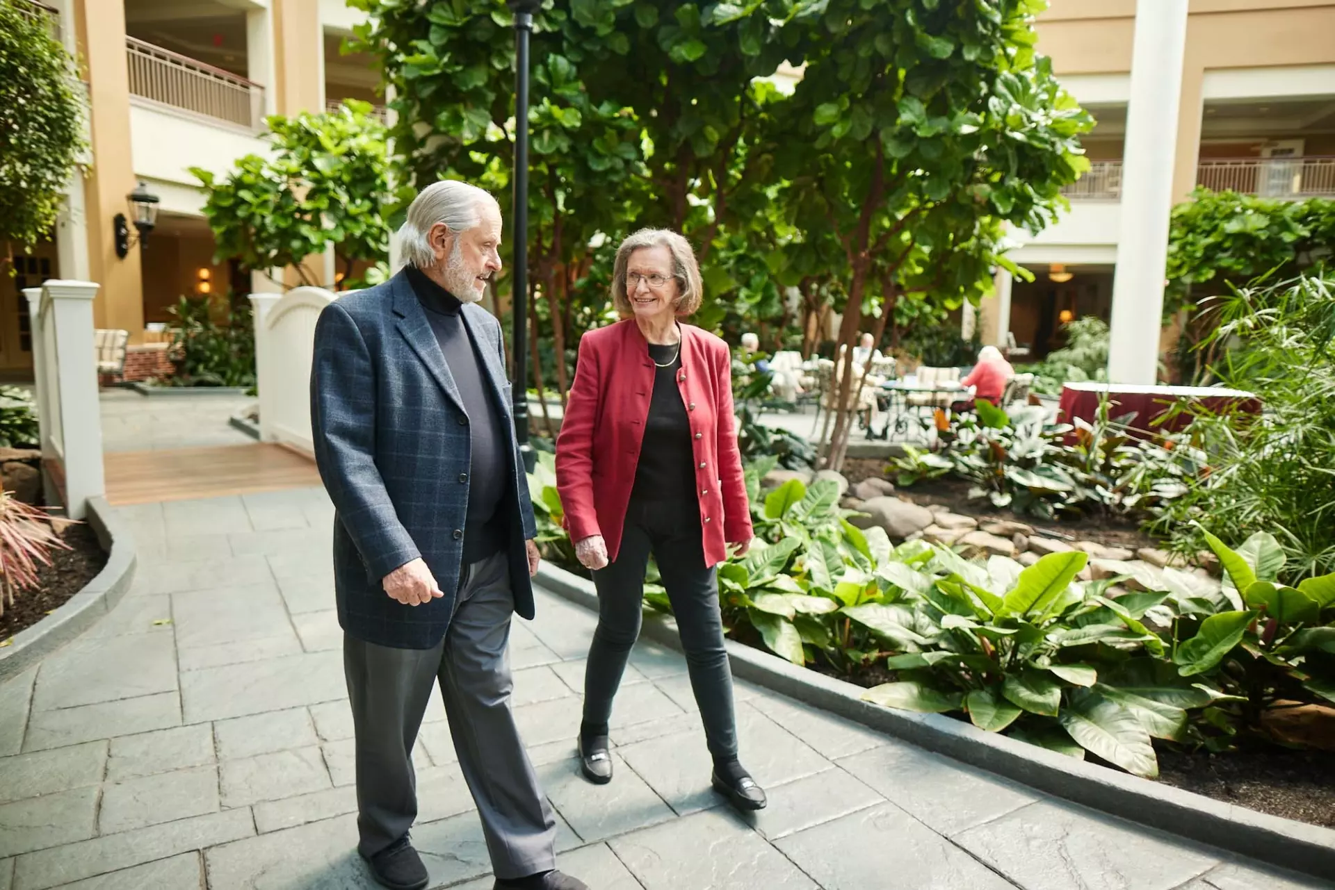 Senior couple walking in indoor garden