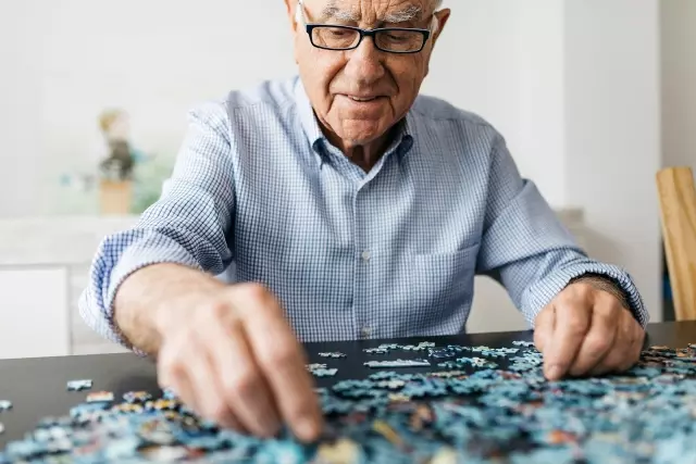 Senior man doing puzzle
