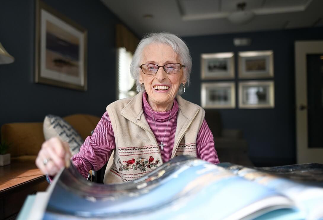 Senior woman looking at scrapbook
