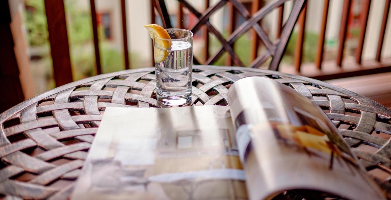 Table with glass of water and magazine
