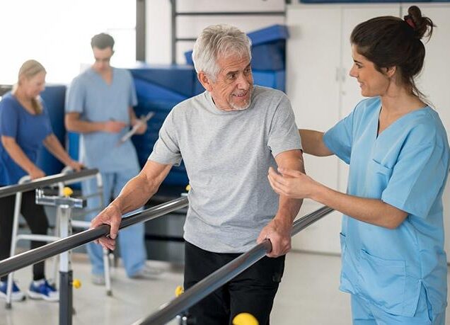 Older man doing injury rehab with nurse