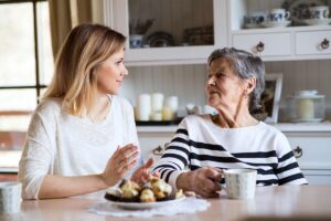 Adult daughter and senior mother speaking