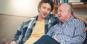 Adult son and senior father talking