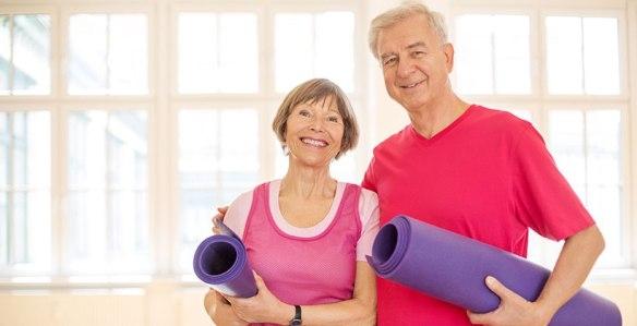 Older man and older woman at yoga class