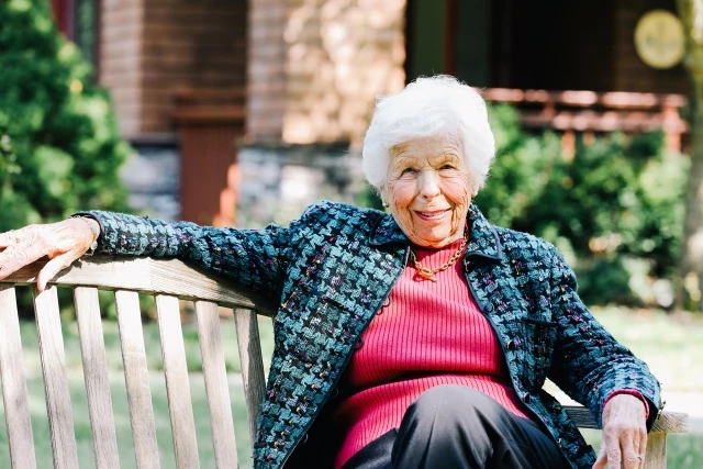 Senior woman sitting on bench outdoors