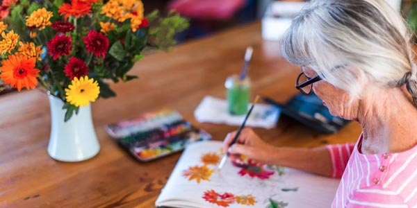 Resident painting flowers