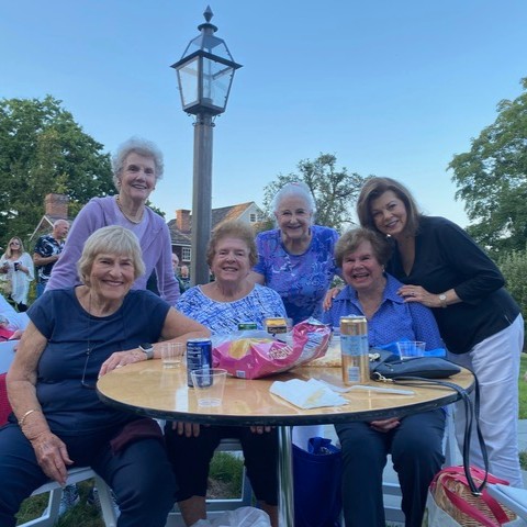 Evie Smick with friends from Edgehill seated at a table smiling