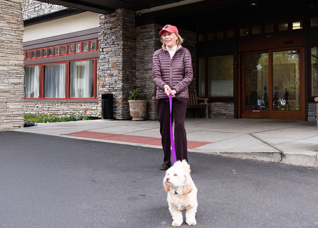 Resident Bo Bartlett walking her dog