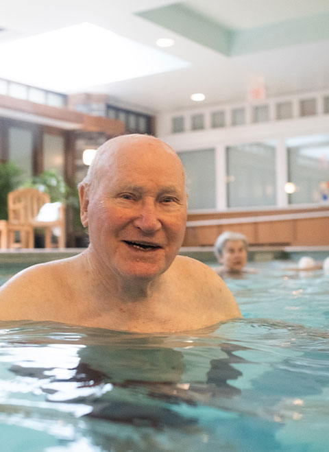 Seniors in swimming aerobics class
