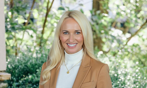 Portrait of Susan Pica, Director of Sales and Marketing at Edgehill, smiling outdoors in a professional blazer.