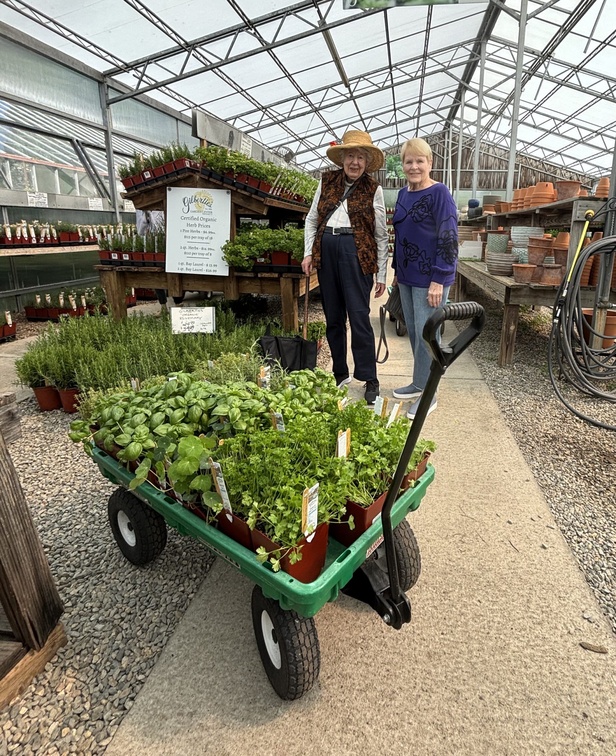 Jean M. and Bev Smith smile while shopping for herb plants, including basil, dill, tarragon and mint, during a gardening outing.