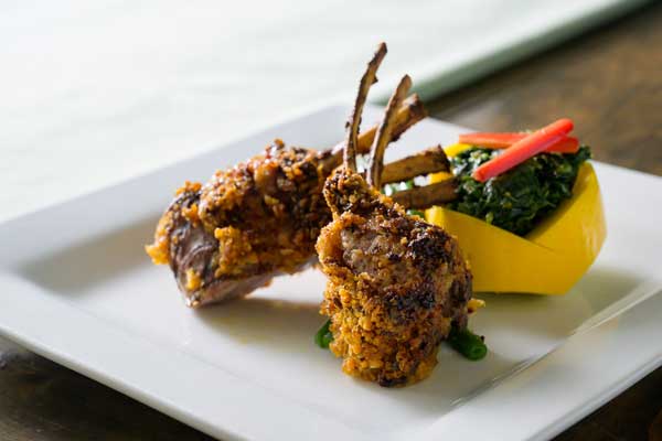 Gourmet crusted lamb chops and spinach salad dish