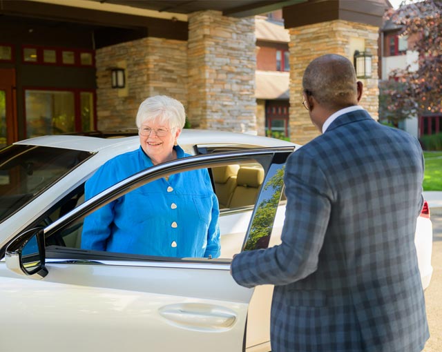 Resident Judy with valet associate