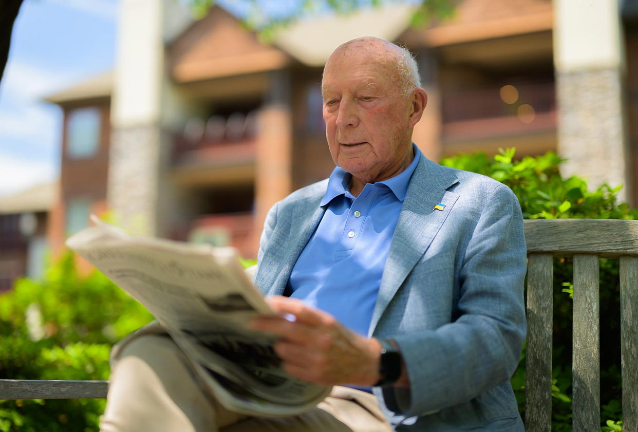 Resident Michael reading the newspaper