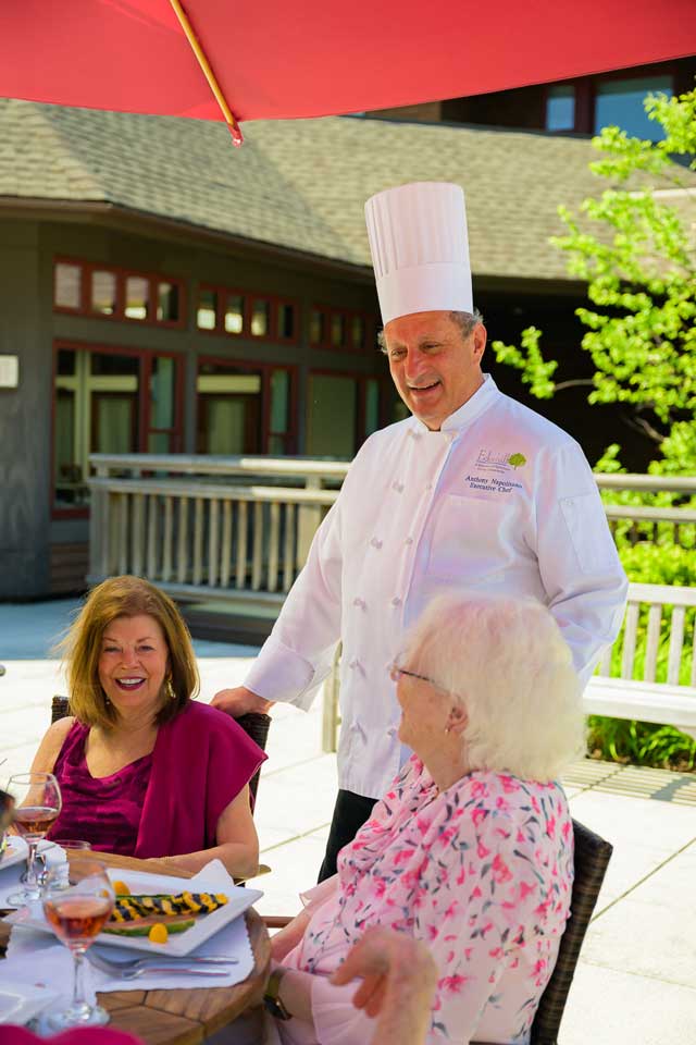 Rooftop deck with residents and executive chef Anthony