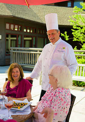 Exterior rooftop deck with residents and executive chef Anthony Napolitano