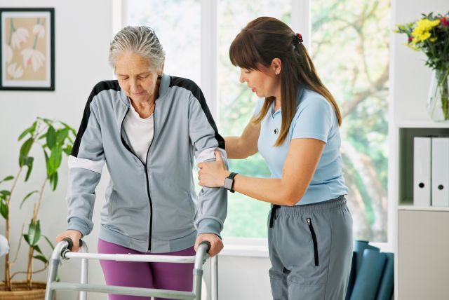 rehabilitation professional supporting older adult